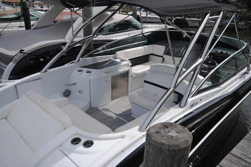Slide: The Image of 2015 Formula 310 Bowrider boat with spacious seating and sleek design at a marina. - 5