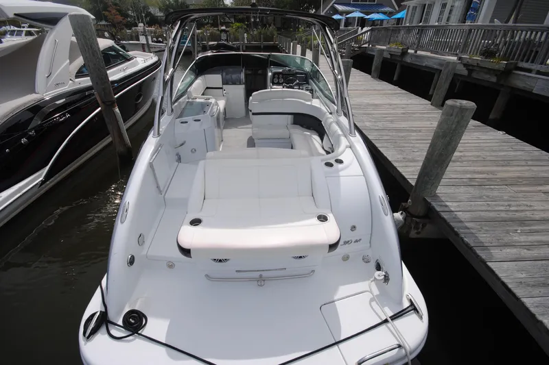 Slide: The Image of 2015 Formula 310 Bowrider docked, showcasing spacious seating and sleek design. - 7