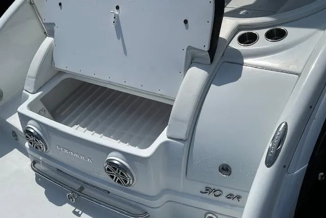 Slide: The Image of 2015 Formula 310 Bowrider boat with open storage compartment and sleek design. - 8