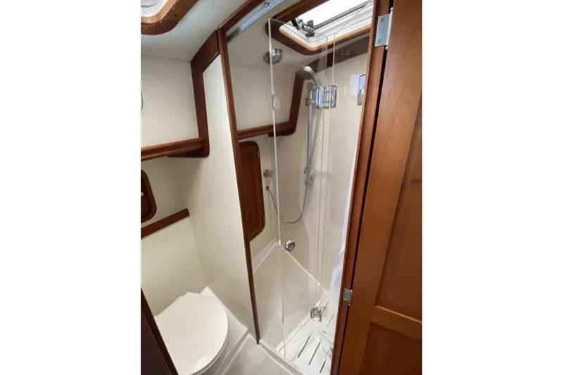 Slide: The Image of 1999 Legacy Yachts 40 Sedan bathroom with shower and wooden accents. - 22