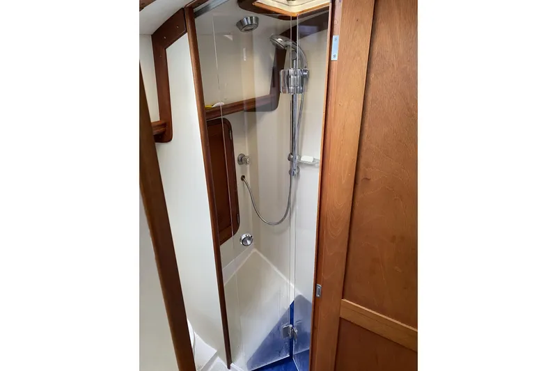Slide: The Image of Shower area in 1999 Legacy Yachts 40 Sedan, featuring wooden accents and modern fixtures. - 23