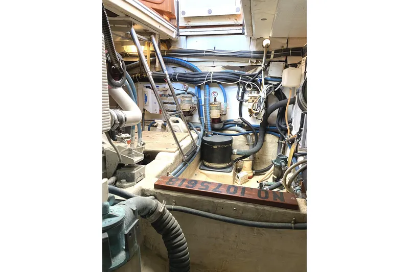Slide: The Image of Engine room of 1999 Legacy Yachts 40 Sedan, showcasing complex machinery and wiring. - 25