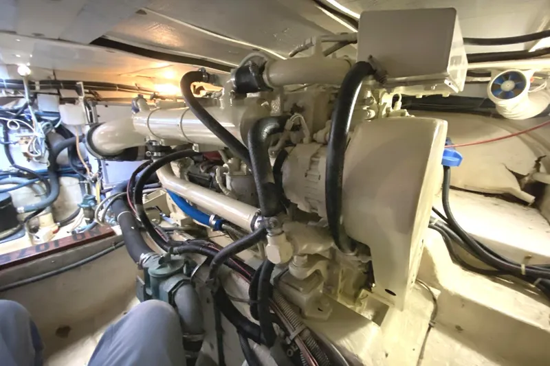 Slide: The Image of Engine room of 1999 Legacy Yachts 40 Sedan, showcasing mechanical components and wiring. - 27