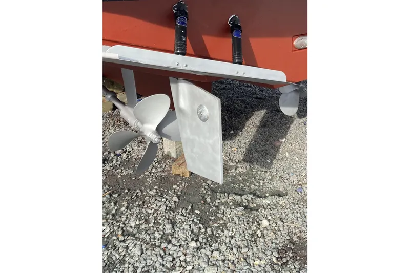 Slide: The Image of Propeller and rudder of 1999 Legacy Yachts 40 Sedan on gravel surface. - 30