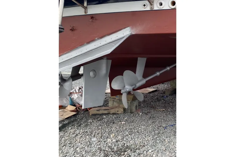 Slide: The Image of Underwater view of 1999 Legacy Yachts 40 Sedan propeller and rudder on gravel. - 31