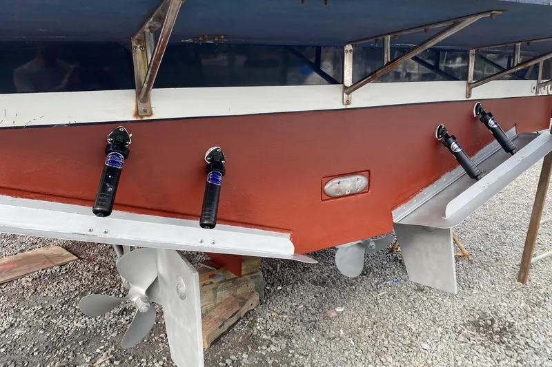 Slide: The Image of 1999 Legacy Yachts 40 Sedan stern view with propellers and trim tabs. - 32