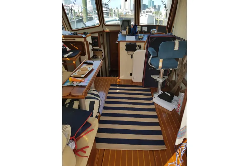 Slide: The Image of Interior of 1999 Legacy Yachts 40 Sedan with striped rug and nautical decor. - 4