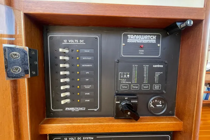 Slide: The Image of Control panel of a 1999 Legacy Yachts 40 Sedan, featuring 12V DC system and tank alert. - 50