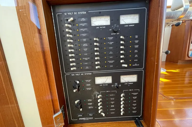 Slide: The Image of Electrical panel on a 1999 Legacy Yachts 40 Sedan, featuring 12V DC and 120V AC systems. - 51