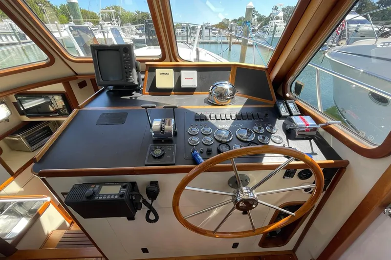 Slide: The Image of Helm of 1999 Legacy Yachts 40 Sedan with navigation instruments and wooden steering wheel. - 53