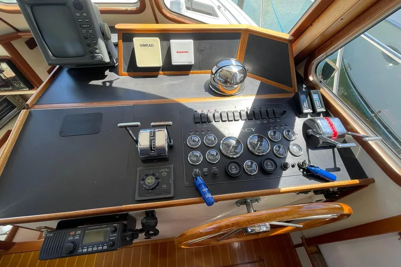 Slide: The Image of 1999 Legacy Yachts 40 Sedan helm with navigation instruments and controls. - 54