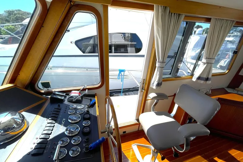 Slide: The Image of Interior view of 1999 Legacy Yachts 40 Sedan helm with controls and seating. - 55