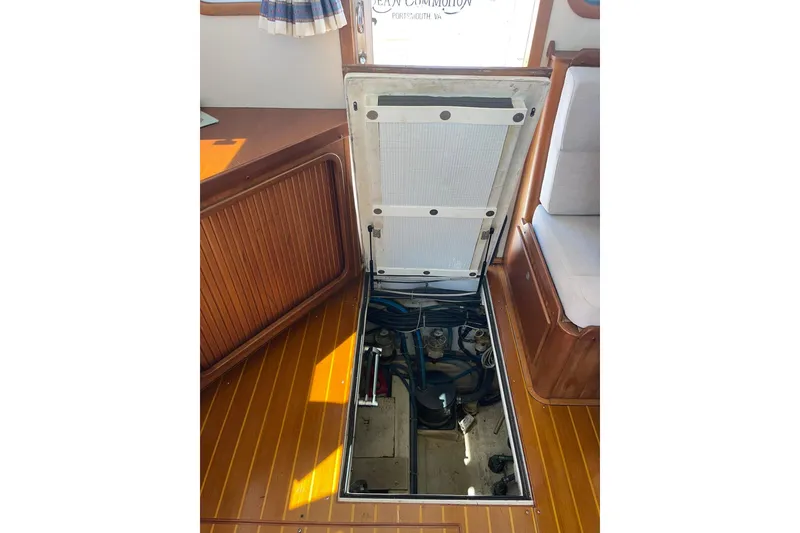 Slide: The Image of 1999 Legacy Yachts 40 Sedan engine compartment with open hatch, showcasing interior mechanics. - 57