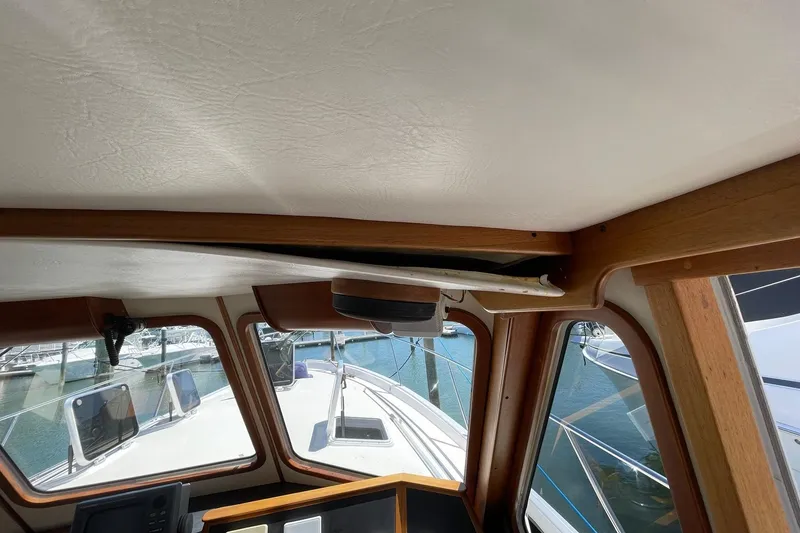 Slide: The Image of Interior view of 1999 Legacy Yachts 40 Sedan, showcasing helm and windows. - 58