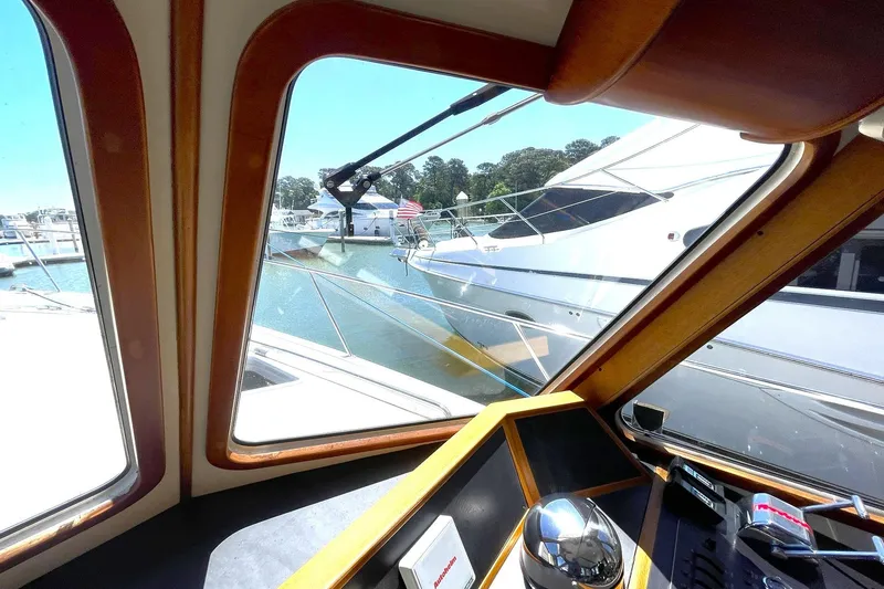 Slide: The Image of Interior view from 1999 Legacy Yachts 40 Sedan, overlooking marina with boats. - 60