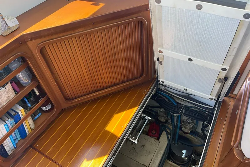 Slide: The Image of Interior view of 1999 Legacy Yachts 40 Sedan engine compartment with wooden cabinetry. - 62