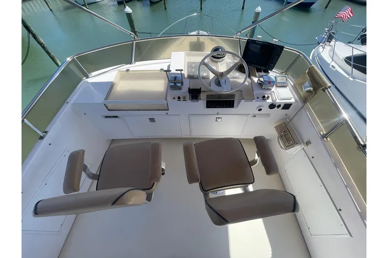 Slide: The Image of Cockpit of 1999 Legacy Yachts 40 Sedan with dual seats and navigation equipment. - 68