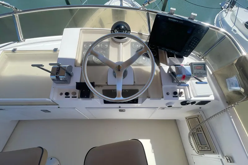 Slide: The Image of Cockpit of 1999 Legacy Yachts 40 Sedan with steering wheel and navigation equipment. - 69