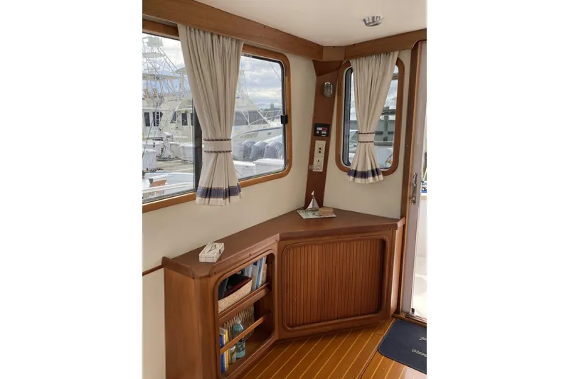 Slide: The Image of Interior of 1999 Legacy Yachts 40 Sedan with wooden cabinetry and nautical decor. - 7