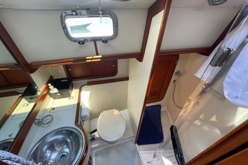 Slide: The Image of Engine room of 1999 Legacy Yachts 40 Sedan, showcasing dual engines and mechanical components. - 71
