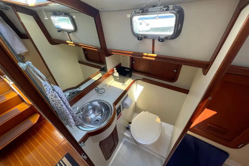 Slide: The Image of Engine room of 1999 Legacy Yachts 40 Sedan, showcasing mechanical components and wiring. - 72