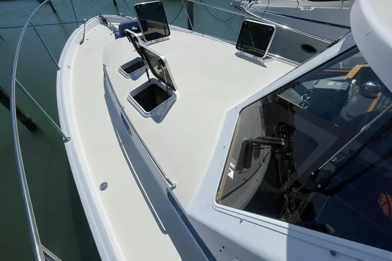 Slide: The Image of 1999 Legacy Yachts 40 Sedan deck view with open hatches and railing. - 82