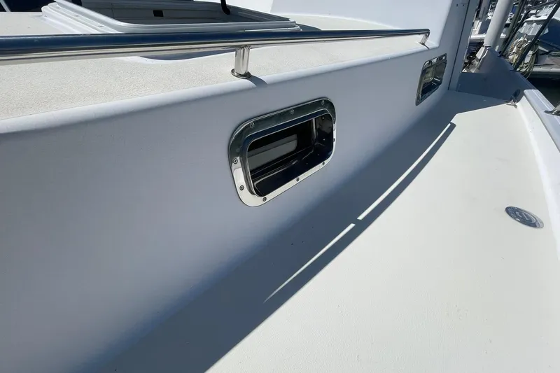 Slide: The Image of 1999 Legacy Yachts 40 Sedan deck with stainless steel railing and porthole. - 89