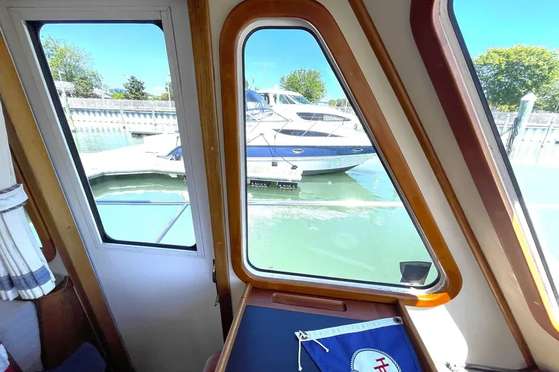 Slide: The Image of 1999 Legacy Yachts 40 Sedan stern view with propellers and trim tabs. - 98
