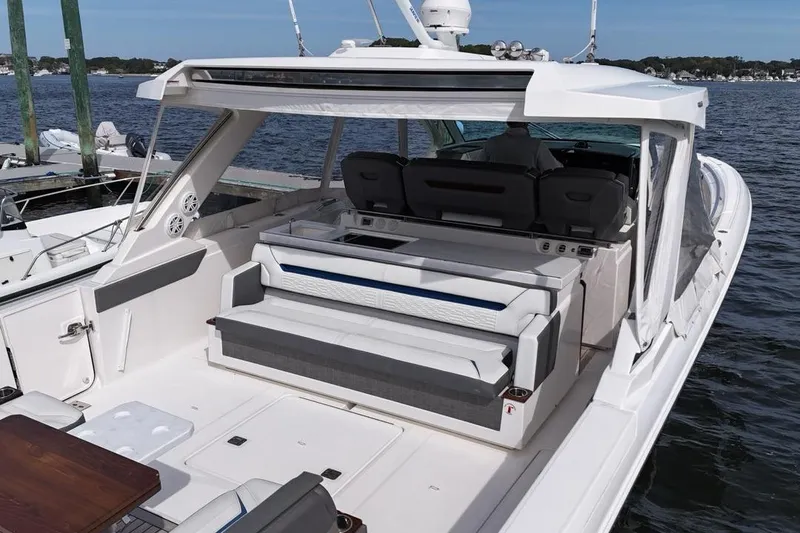 Slide: The Image of 2021 Tiara Sport 43 LS luxury boat with spacious seating and sleek design on the water. - 11
