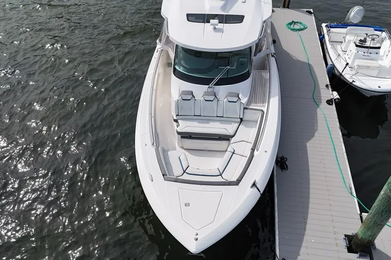 Slide: The Image of 2021 Tiara Sport 43 LS luxury boat docked, aerial view. - 16