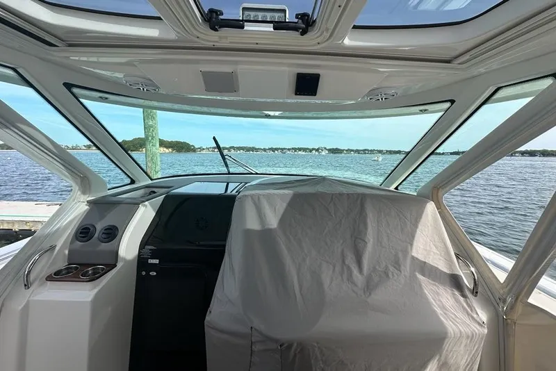 Slide: The Image of Interior view of 2021 Tiara Sport 43 LS boat with scenic water backdrop. - 17