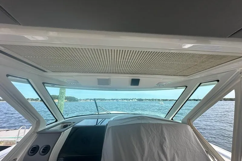 Slide: The Image of Interior view of 2021 Tiara Sport 43 LS yacht overlooking serene waters. - 19