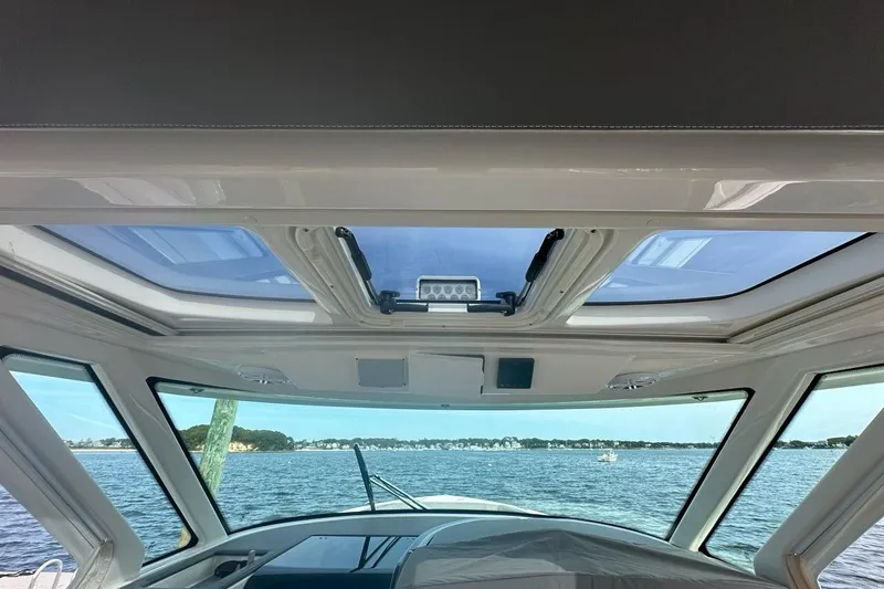 Slide: The Image of Interior view of 2021 Tiara Sport 43 LS yacht with panoramic windows and ocean scenery. - 20