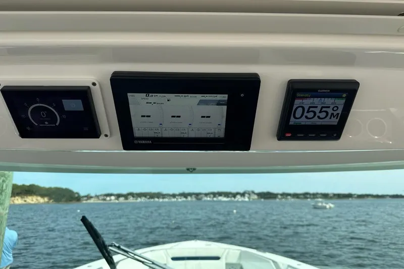 Slide: The Image of Dashboard of 2021 Tiara Sport 43 LS boat with digital displays and scenic water view. - 22