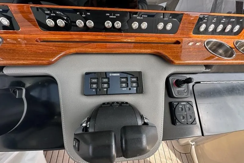 Slide: The Image of Dashboard of 2021 Tiara Sport 43 LS boat with Yamaha controls and wooden paneling. - 24