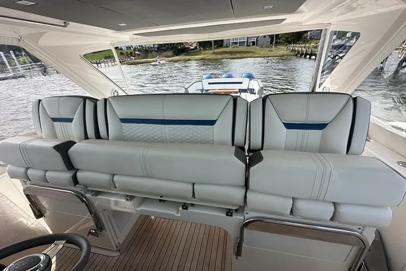 Slide: The Image of 2021 Tiara Sport 43 LS boat interior with luxurious seating and scenic water view. - 27