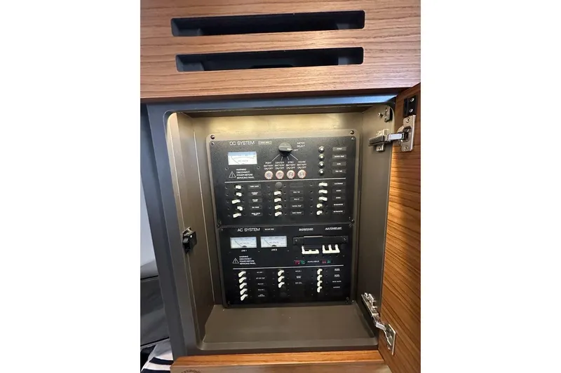 Slide: The Image of Electrical panel inside 2021 Tiara Sport 43 LS boat, featuring DC and AC systems. - 33