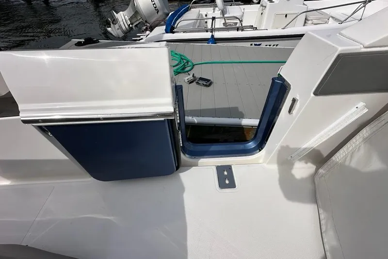 Slide: The Image of 2021 Tiara Sport 43 LS boat deck with open hatch and visible equipment. - 39
