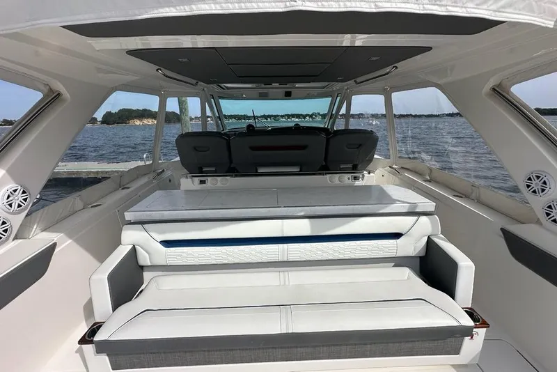Slide: The Image of Interior view of 2021 Tiara Sport 43 LS yacht with luxurious seating and ocean backdrop. - 50