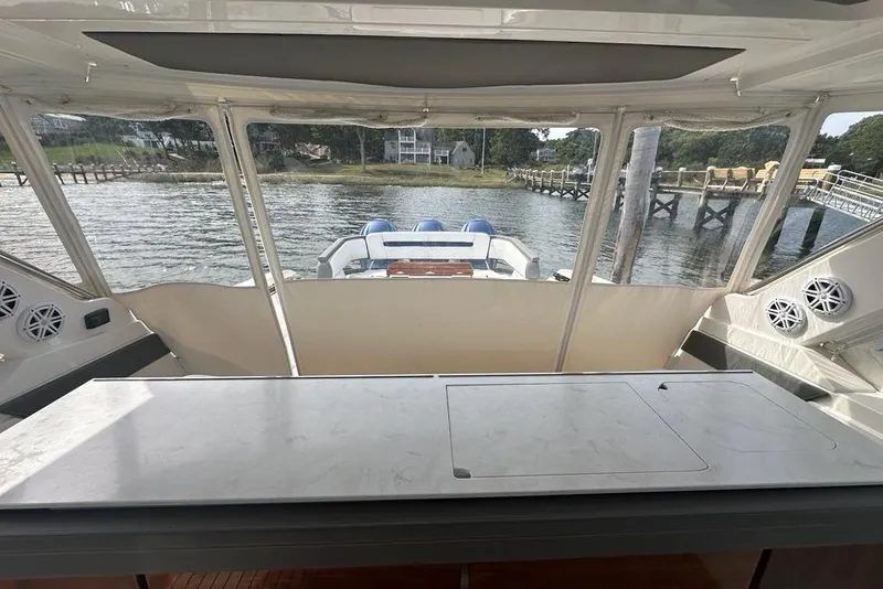 Slide: The Image of 2021 Tiara Sport 43 LS boat interior with waterfront view and modern amenities. - 51