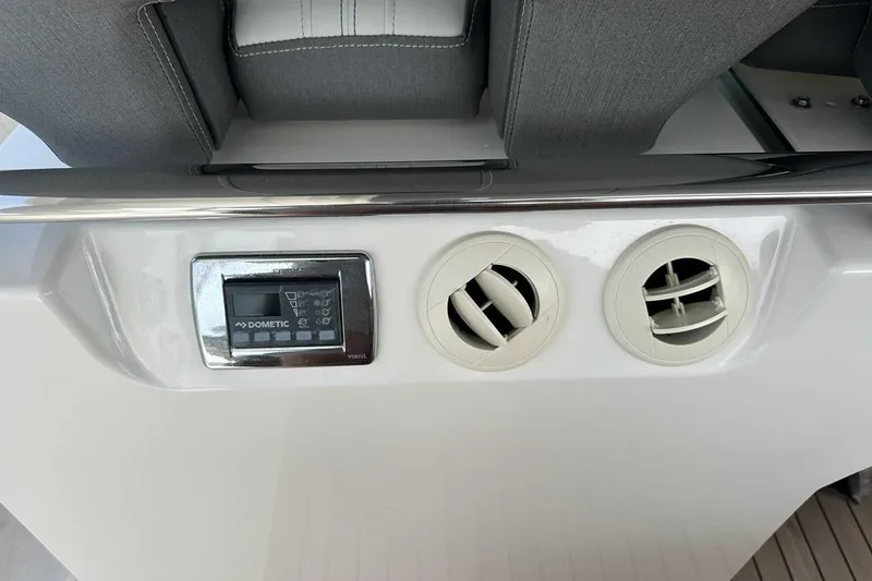 Slide: The Image of 2021 Tiara Sport 43 LS boat interior with Dometic control panel and air vents. - 55