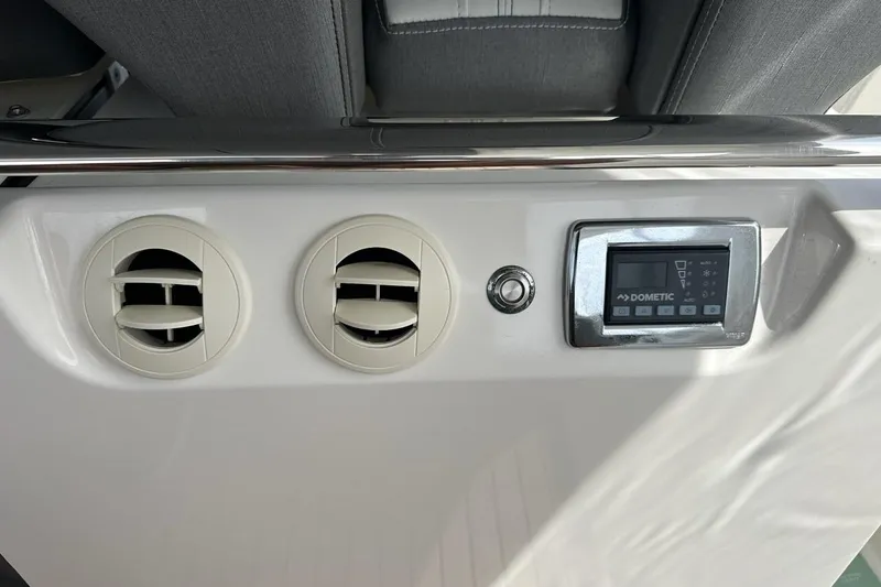 Slide: The Image of 2021 Tiara Sport 43 LS dashboard with air vents and Dometic control panel. - 56