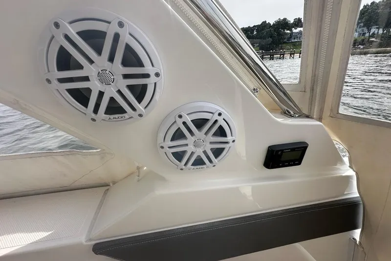Slide: The Image of 2021 Tiara Sport 43 LS boat interior with JL Audio speakers and control panel. - 57