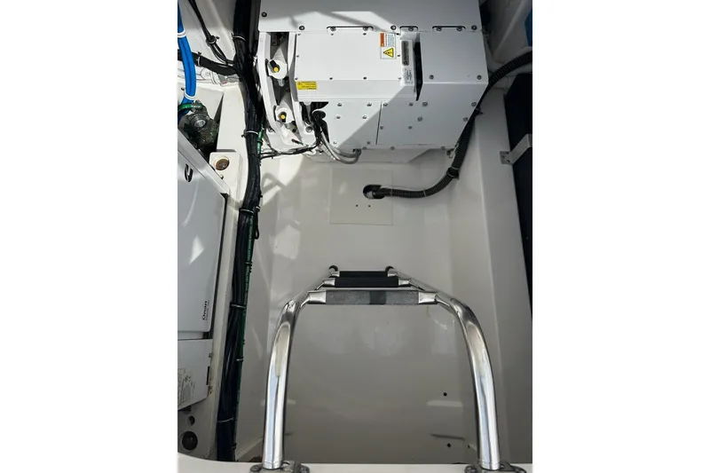 Slide: The Image of Engine compartment of 2021 Tiara Sport 43 LS boat with visible wiring and components. - 58