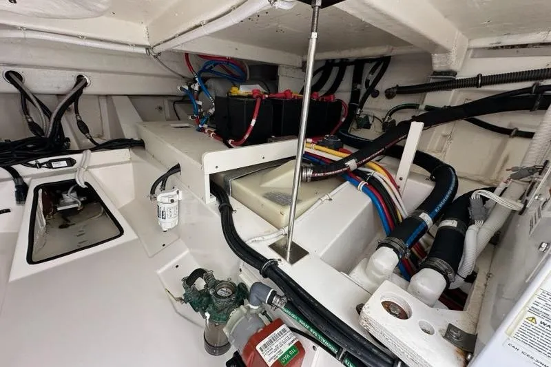 Slide: The Image of Engine compartment of 2021 Tiara Sport 43 LS with wiring and components visible. - 65