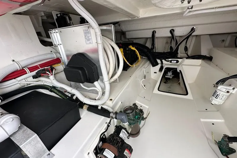 Slide: The Image of Engine compartment of 2021 Tiara Sport 43 LS boat, showcasing wiring and mechanical components. - 66