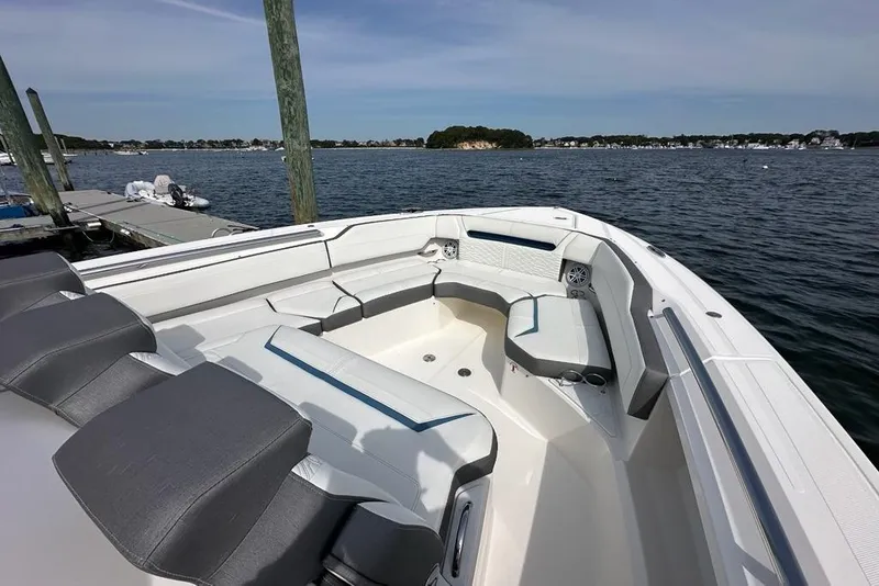Slide: The Image of 2021 Tiara Sport 43 LS boat interior with seating, docked by the water. - 69