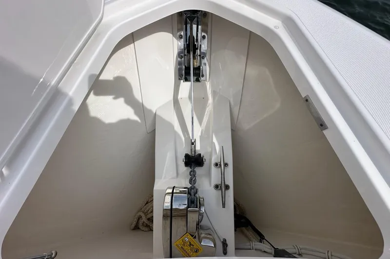 Slide: The Image of Anchor compartment of 2021 Tiara Sport 43 LS boat, featuring chain and winch. - 70