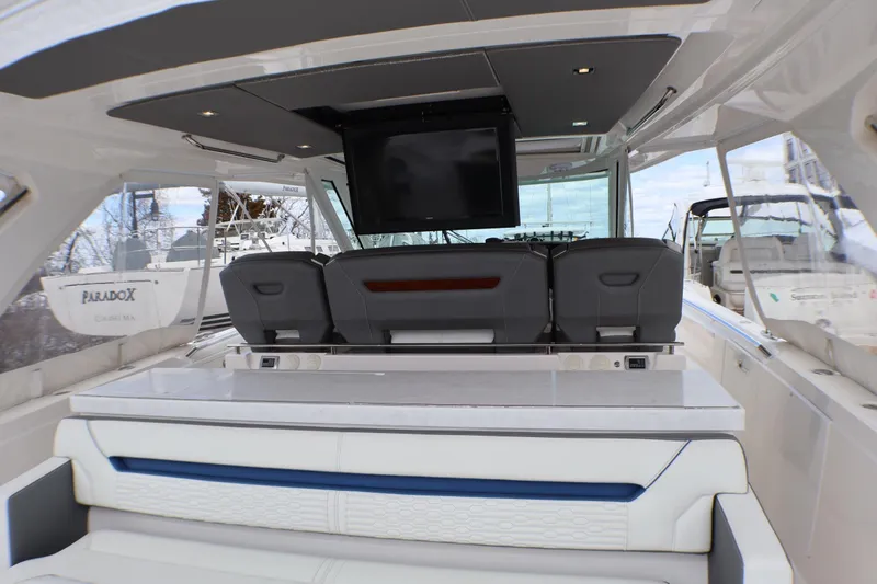 Slide: The Image of 2021 Tiara Sport 43 LS luxury boat interior with seating and TV. - 82