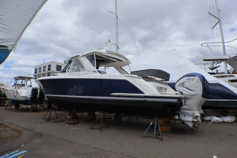 Slide: The Image of 2021 Tiara Sport 43 LS boat on stands, featuring sleek design and Yamaha outboard engines. - 87